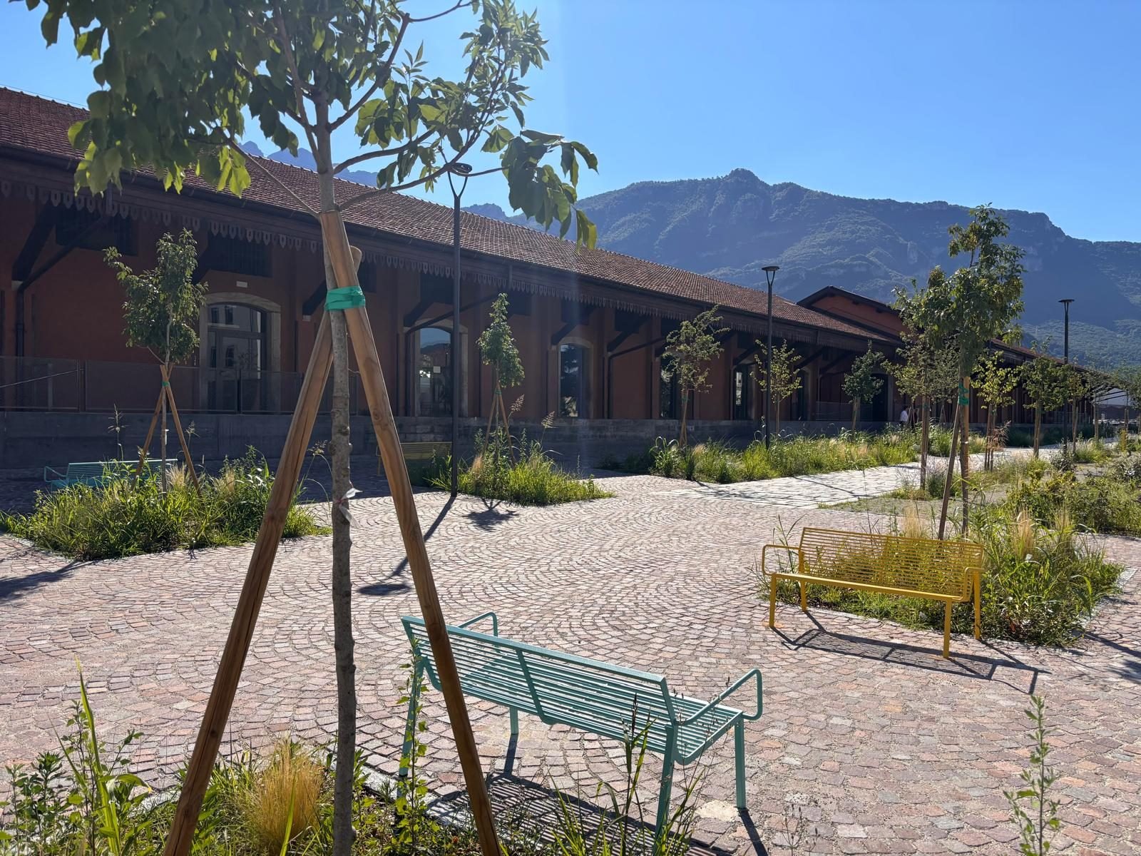 Benches among the planted beds along the goods shed